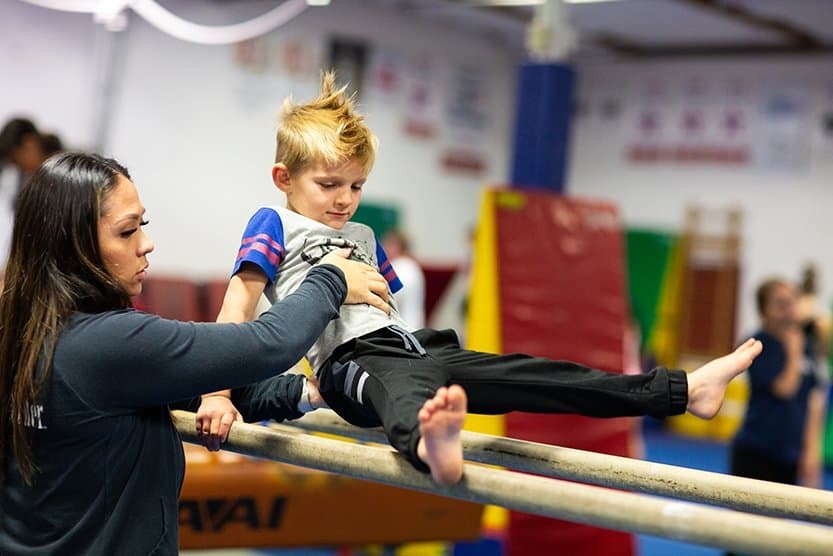 boys doing gymnastics on parallell bars