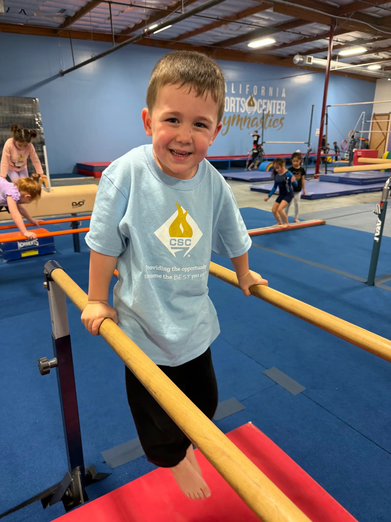 little boy on parallel bars